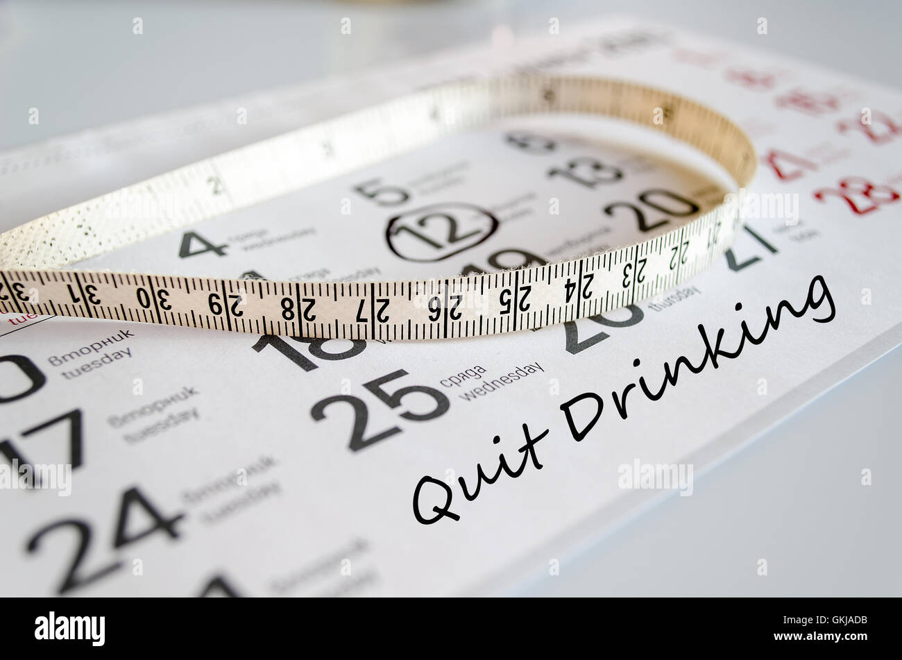 Quit drinking text concept over tape measure and calendar background Quit drinking text concept over tape measure and calendar background