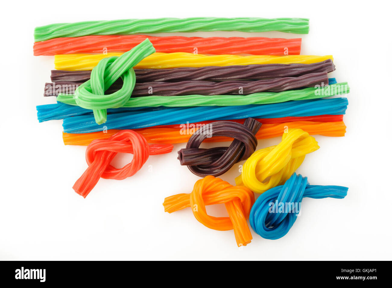 colorful licorice candy shaped like a twisted rope on white background Stock Photo