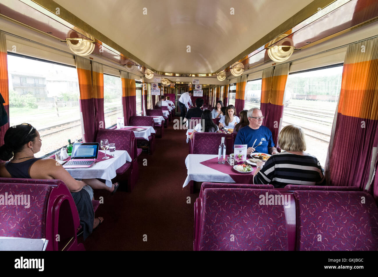 1st class train passengers having lunch on board a restaurant car on a Hungarian Inter-city (IC) train from Budapest  in Hungary Stock Photo