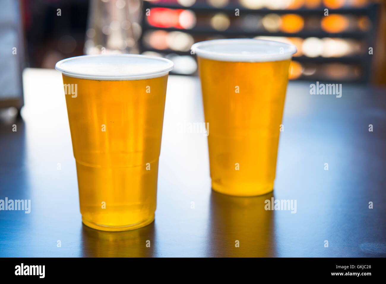 Two plastic glasses of beer. Stock Photo