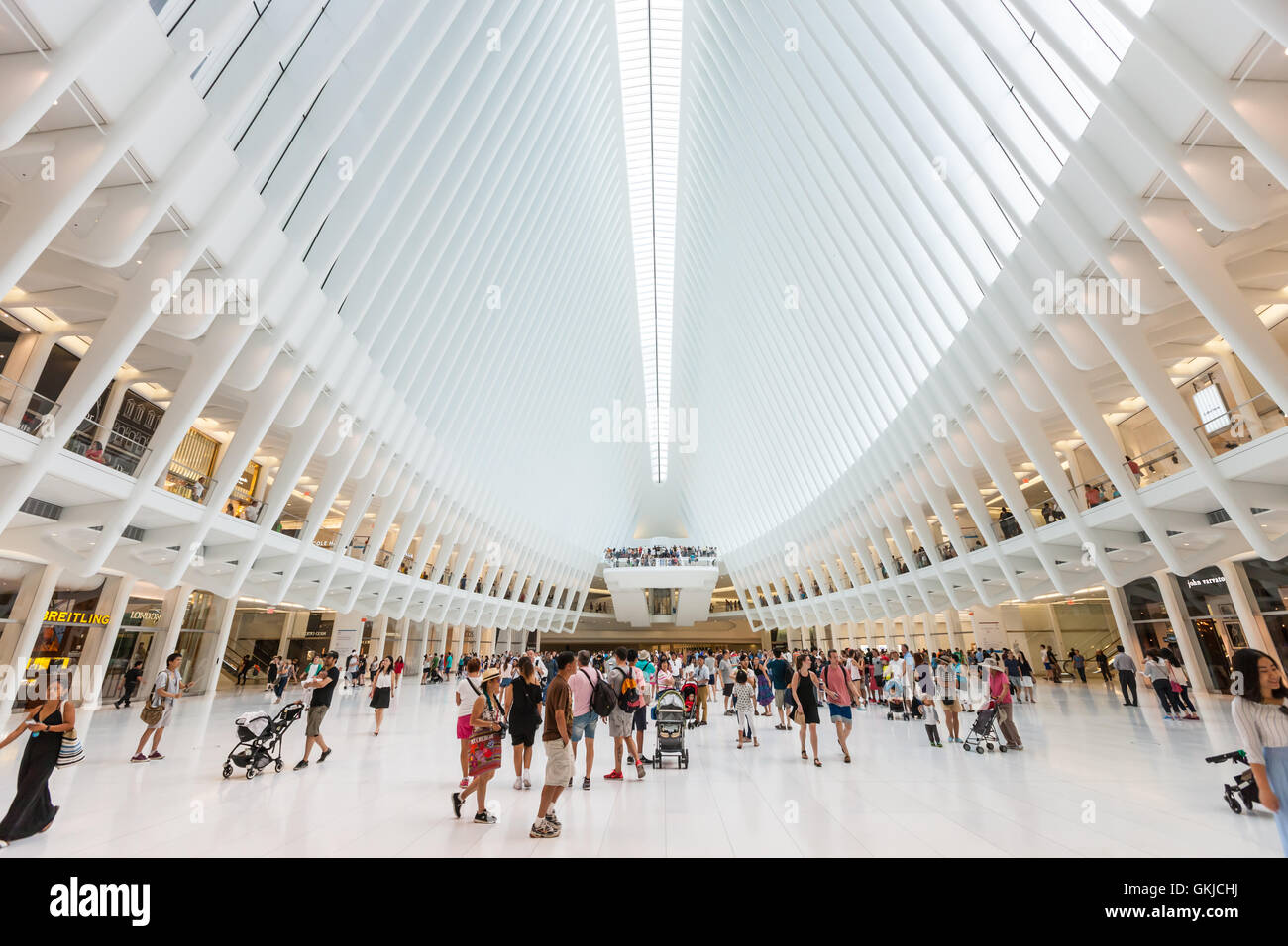 Shoppers and tourists enjoy the view inside the Oculus and stores in the Westfield World Trade Center mall in New York City. Stock Photo