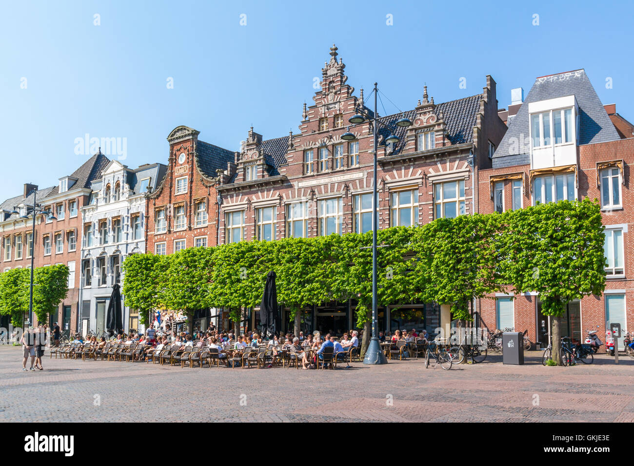 People relaxing on sidewalk cafe on Grote Markt market square in city centre of Haarlem, Holland, Netherlands Stock Photo