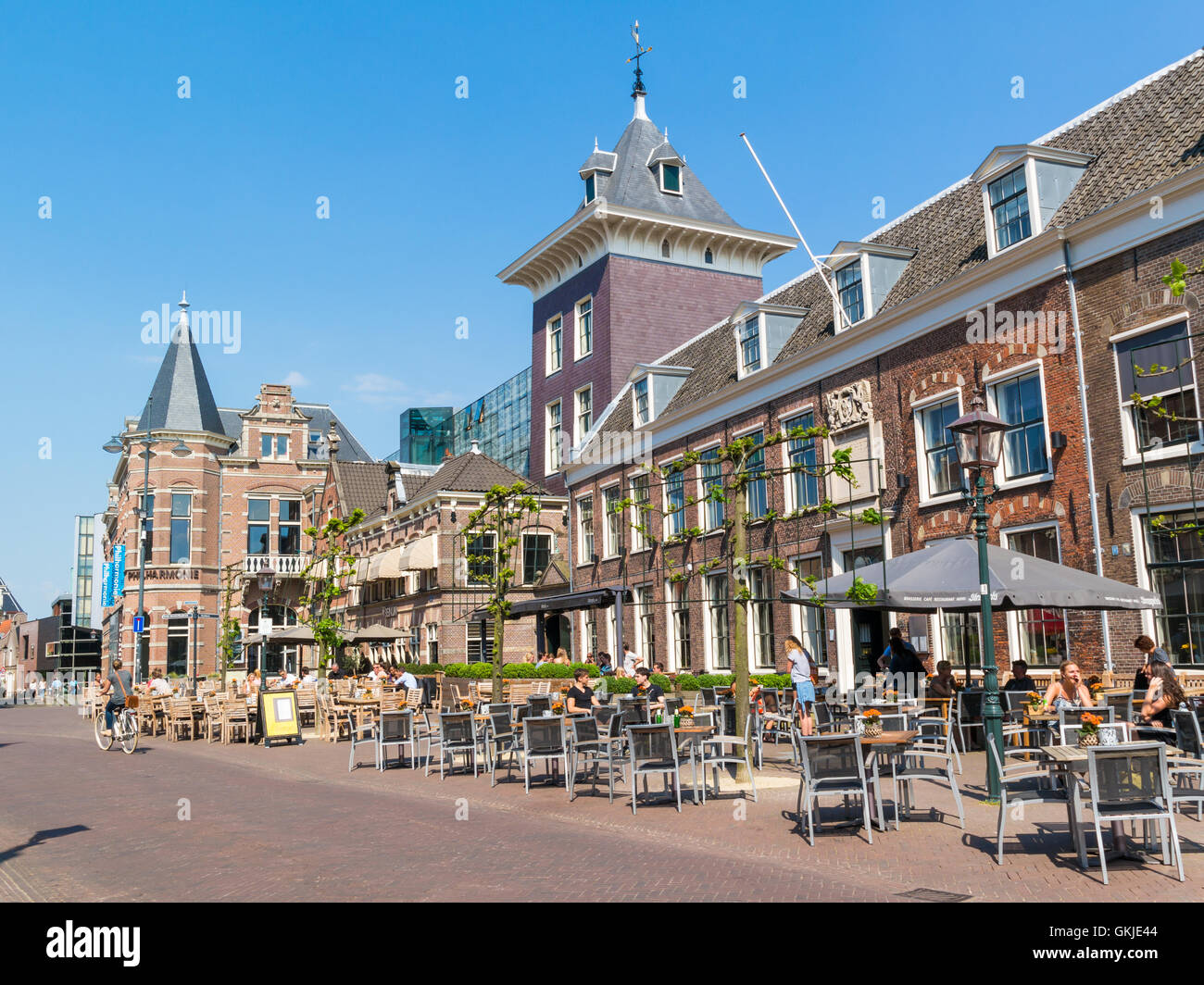 Klokhuisplein square with sidewalk cafe and people in old town of Haarlem, Holland, Netherlands Stock Photo