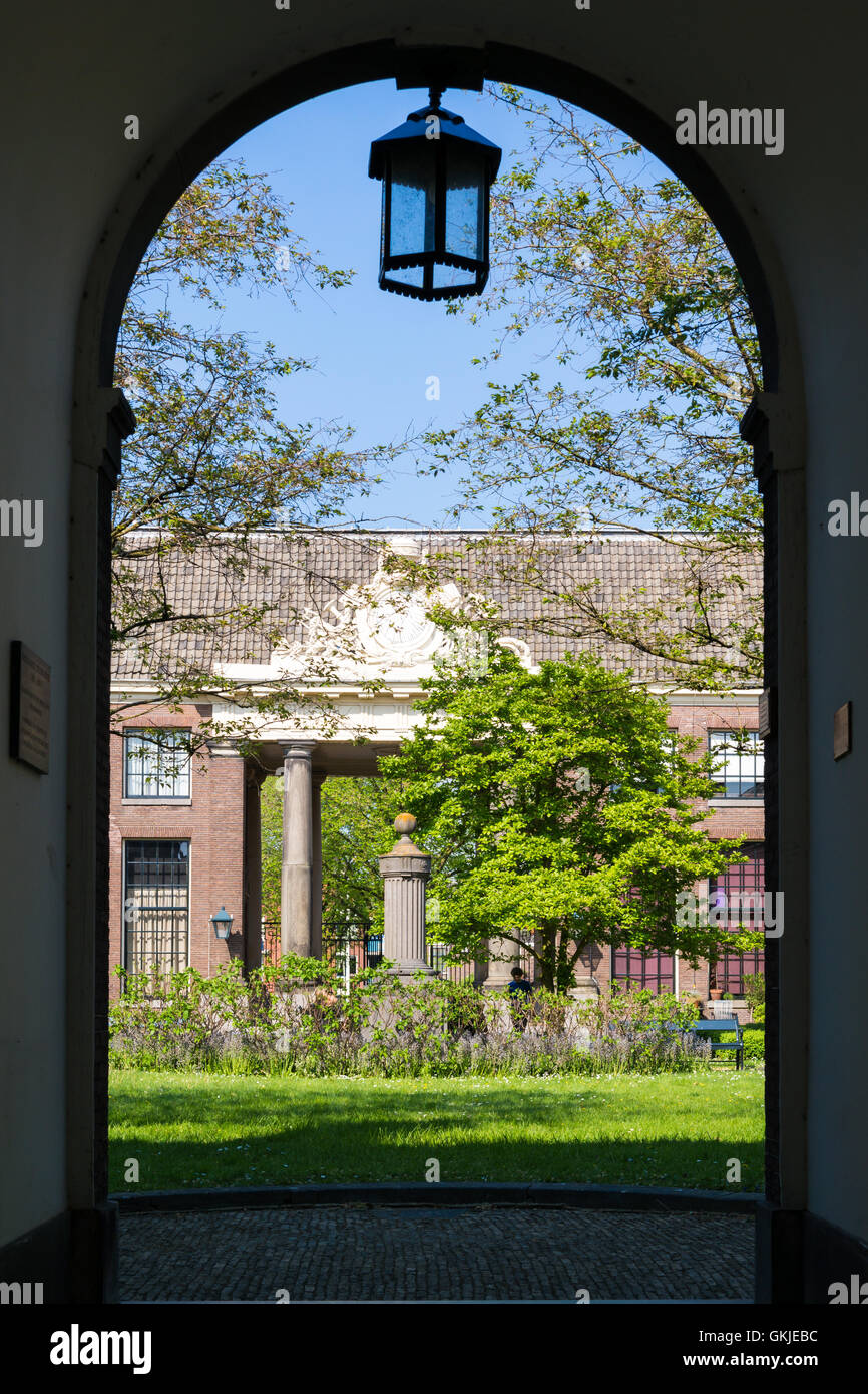 Entrance to courtyard of Teylershofje with garden and almshouses in Haarlem, Holland, Netherlands Stock Photo