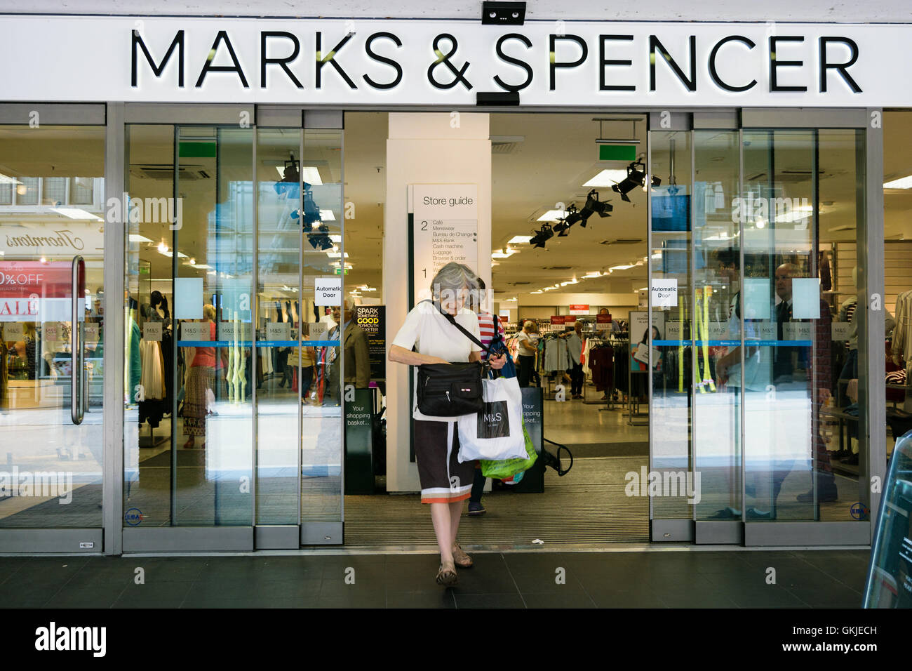 Exeter, United Kingdom - August 18, 2016: Customer exits Marks & Spencer store in Exeter. Stock Photo