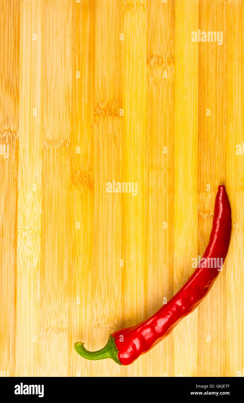 Red chili pepper on a wooden background Stock Photo - Alamy