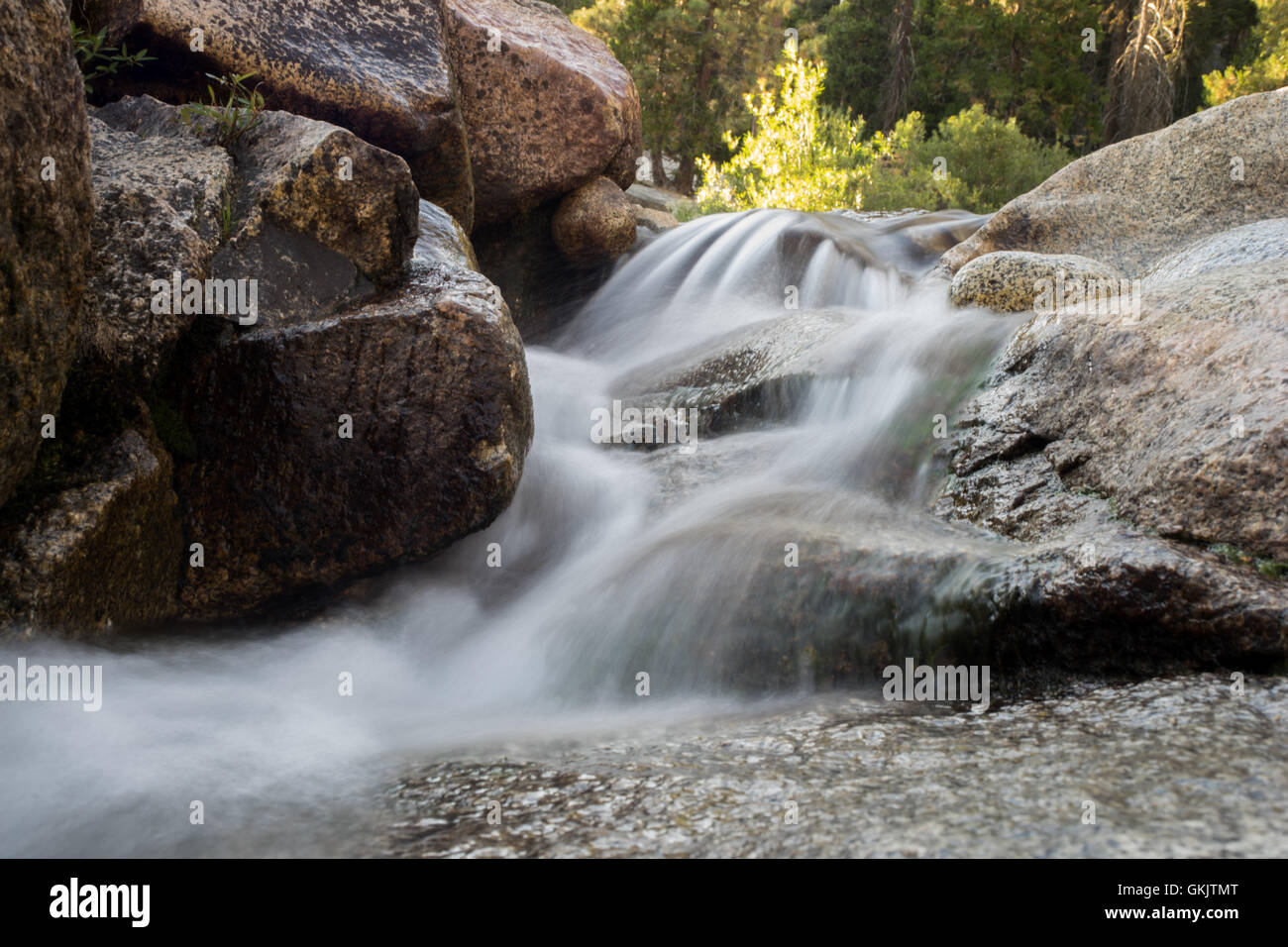 Smooth water flowing over rocks Stock Photo - Alamy
