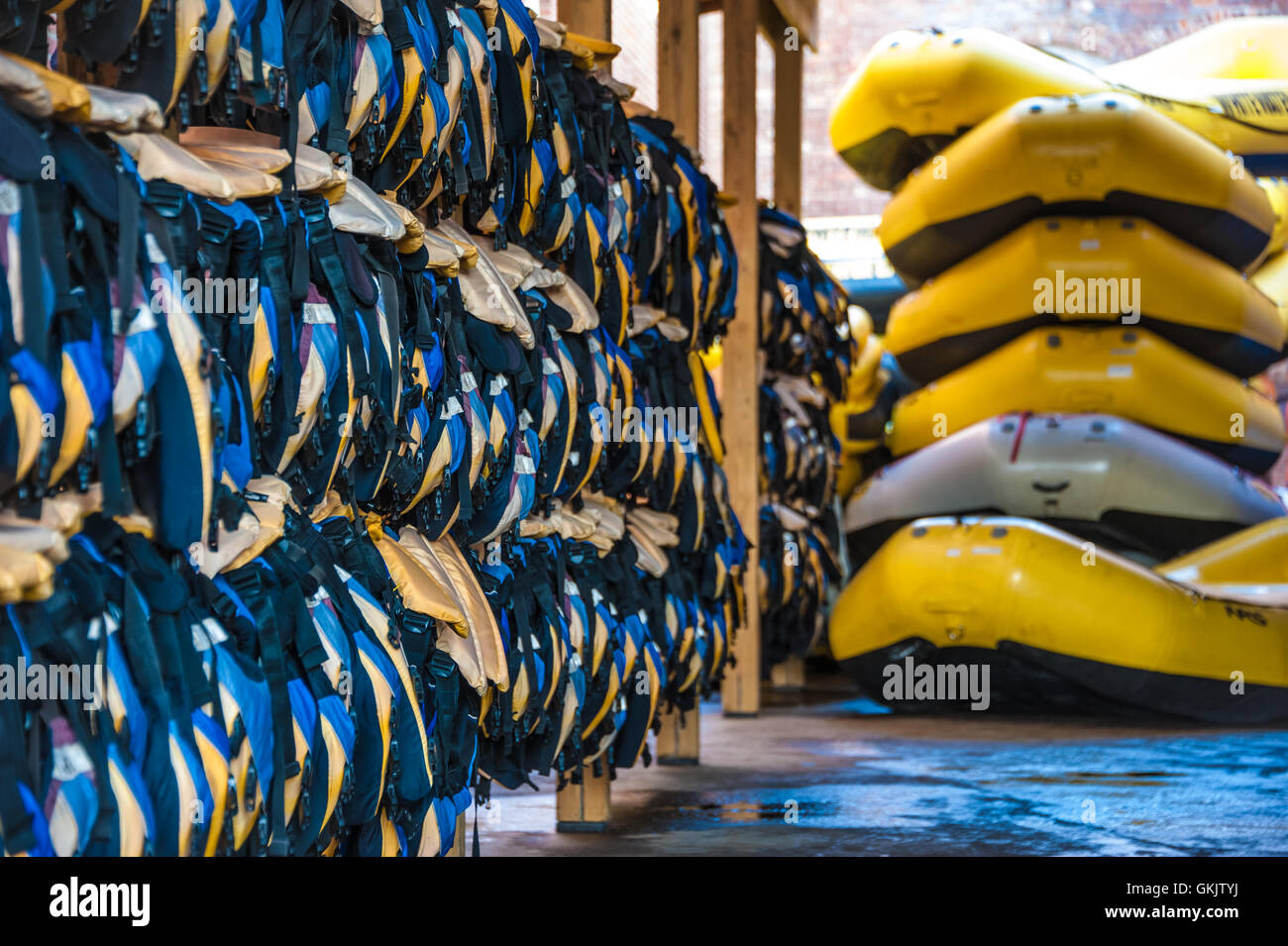 Life vests and rubber rafts ready for whitewater rafting action in Columbus, Georgia on the Chattahoochee River. (USA) Stock Photo