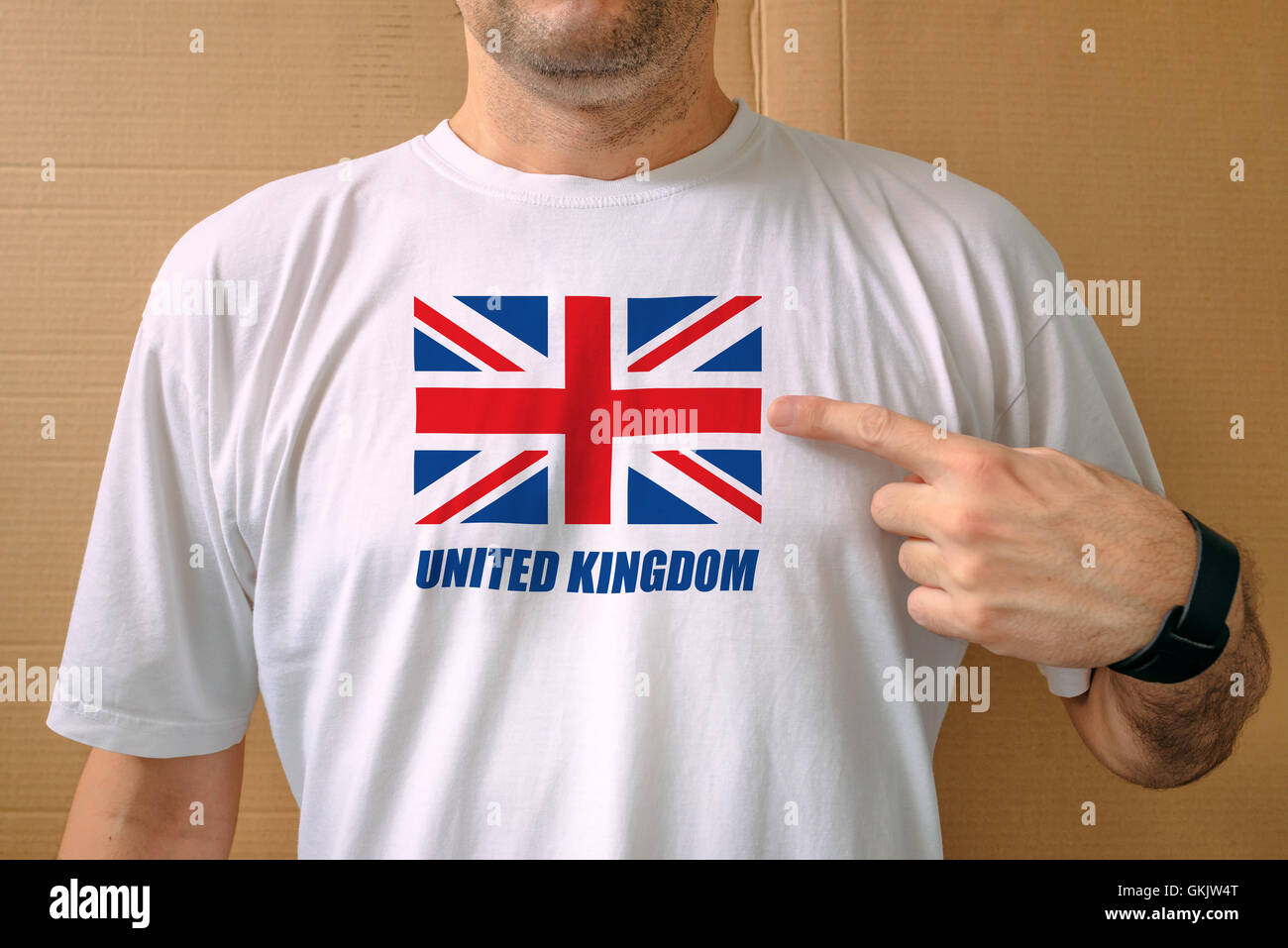 Handsome man proudly wearing white t-shirt with United Kingdom flag printed on chest, concept of patriotism, national pride and Stock Photo