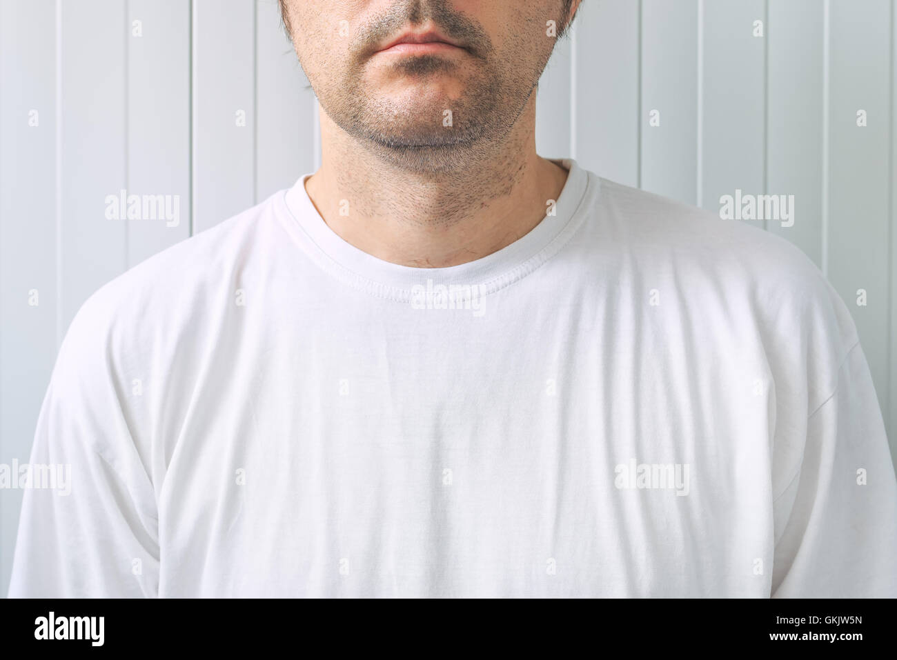 Casual adult male wearing blank white t-shirt as copy space for graphic design mock up Stock Photo