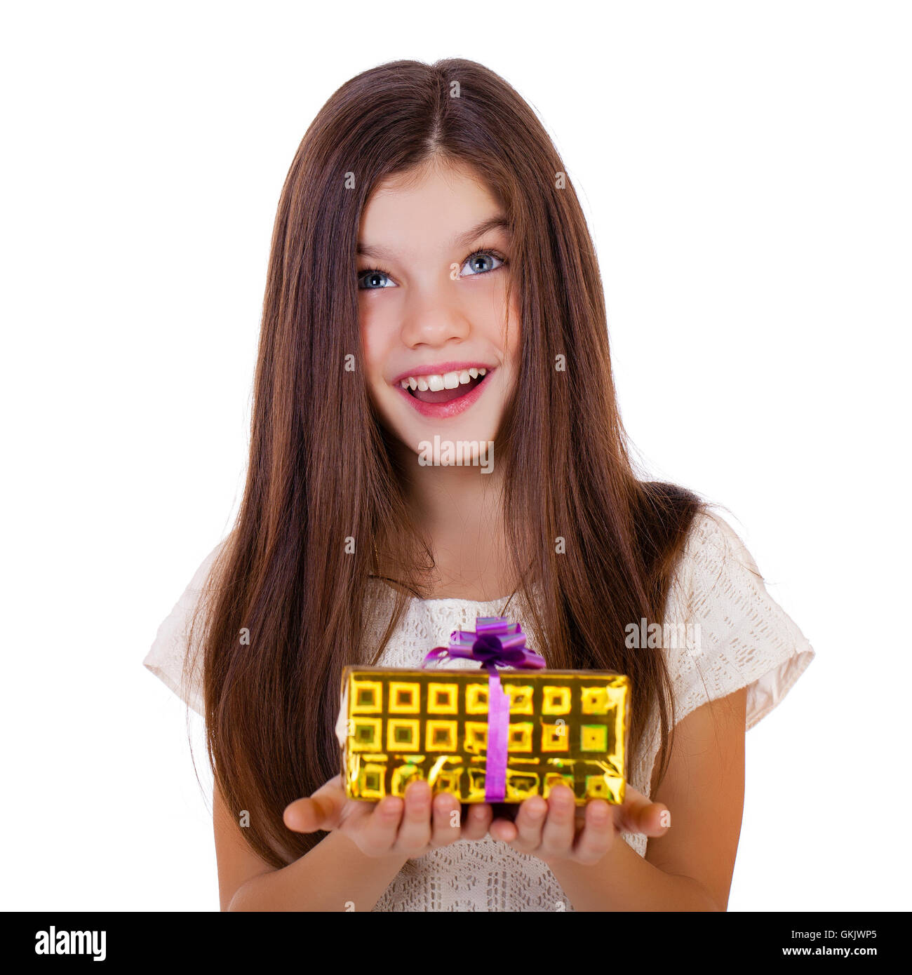 Happy smiling little girl holding and offering a gift for Christmas and