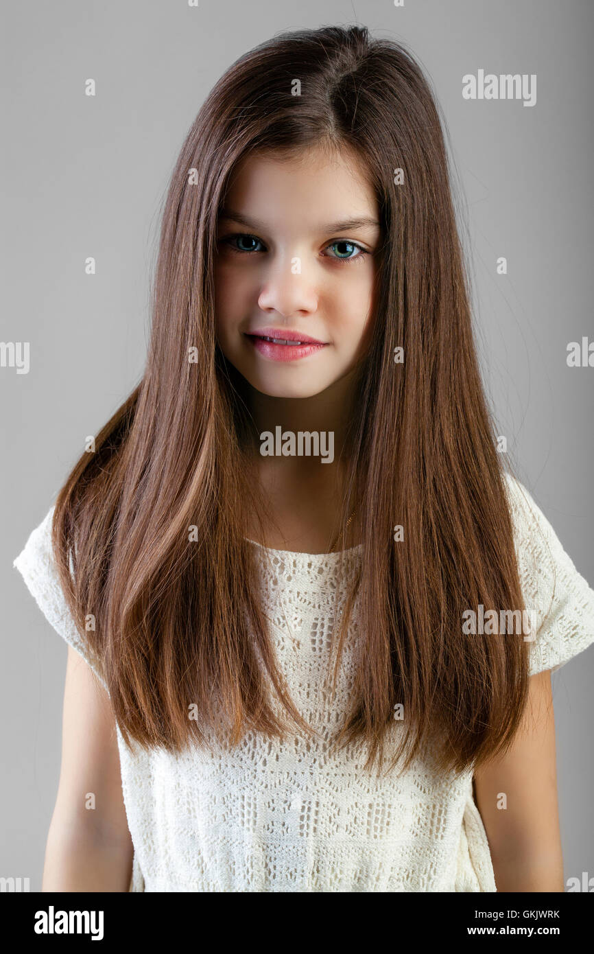 Portrait Of A Charming Brunette Little Girl Isolated On Gray portrait-of-a-charming-brunette-little-girl-isolated-on-gray
