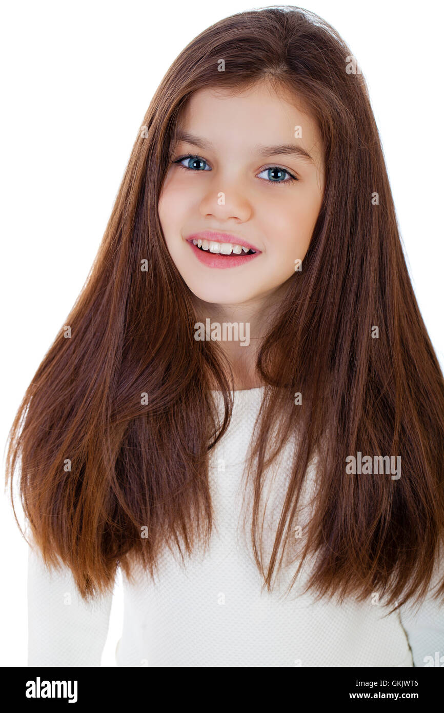 Portrait of a charming little girl smiling at camera, isolated on white ...