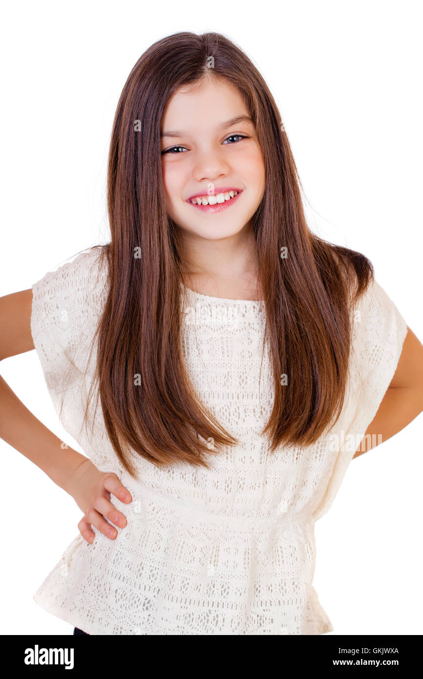 Portrait of a charming little girl smiling at camera, isolated on white ...