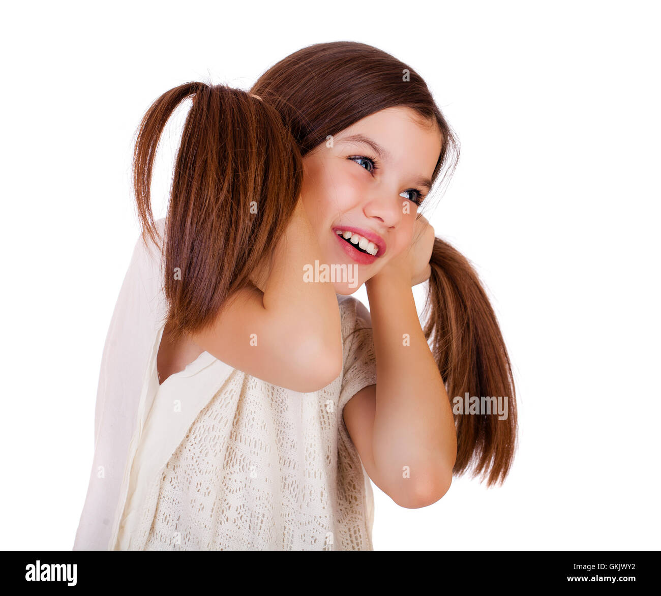 Portrait of a charming little girl smiling at camera, isolated on white ...