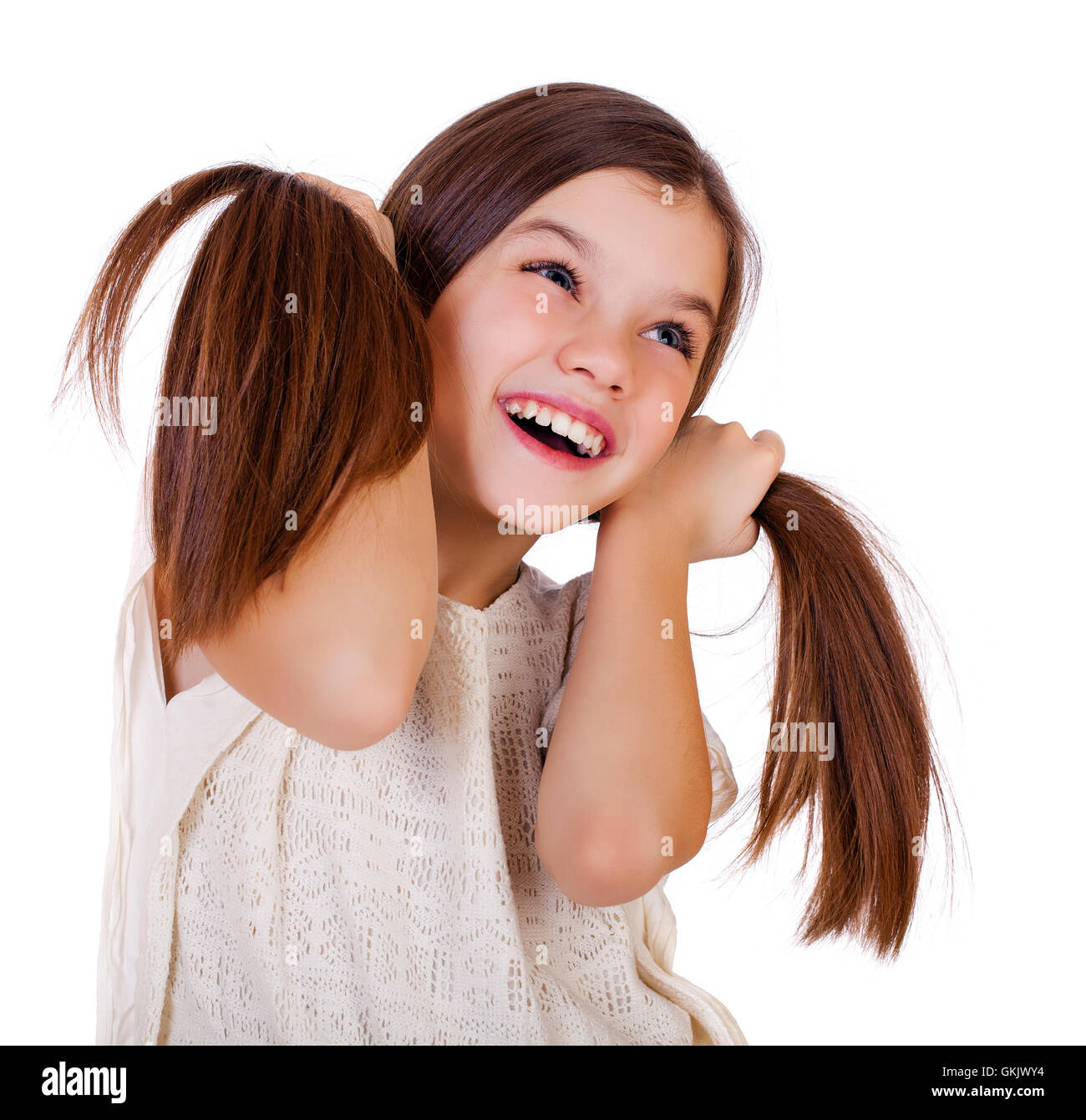 Portrait of a charming little girl smiling at camera, isolated on white ...