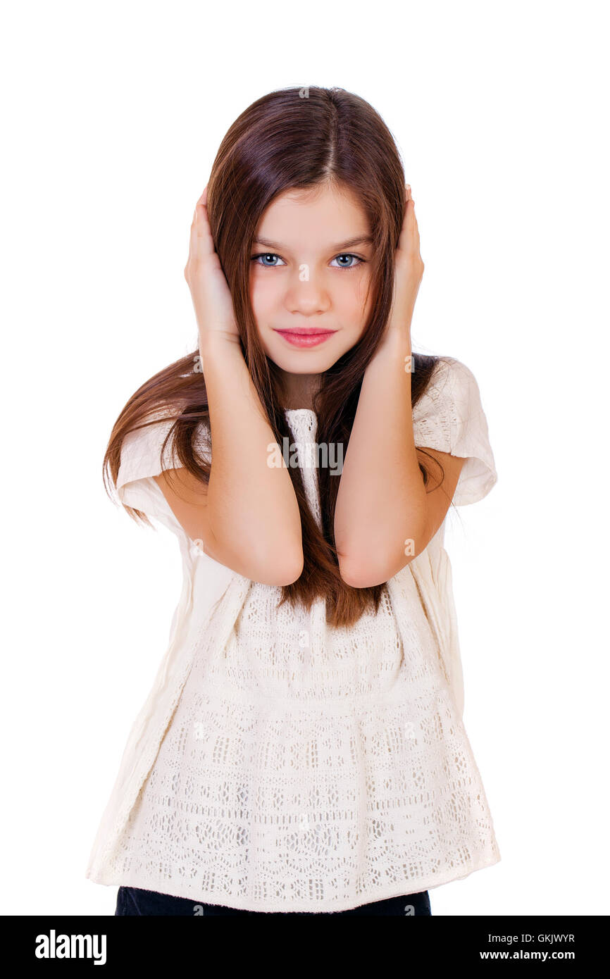 Portrait of a charming little girl covering ears with hands, isolated