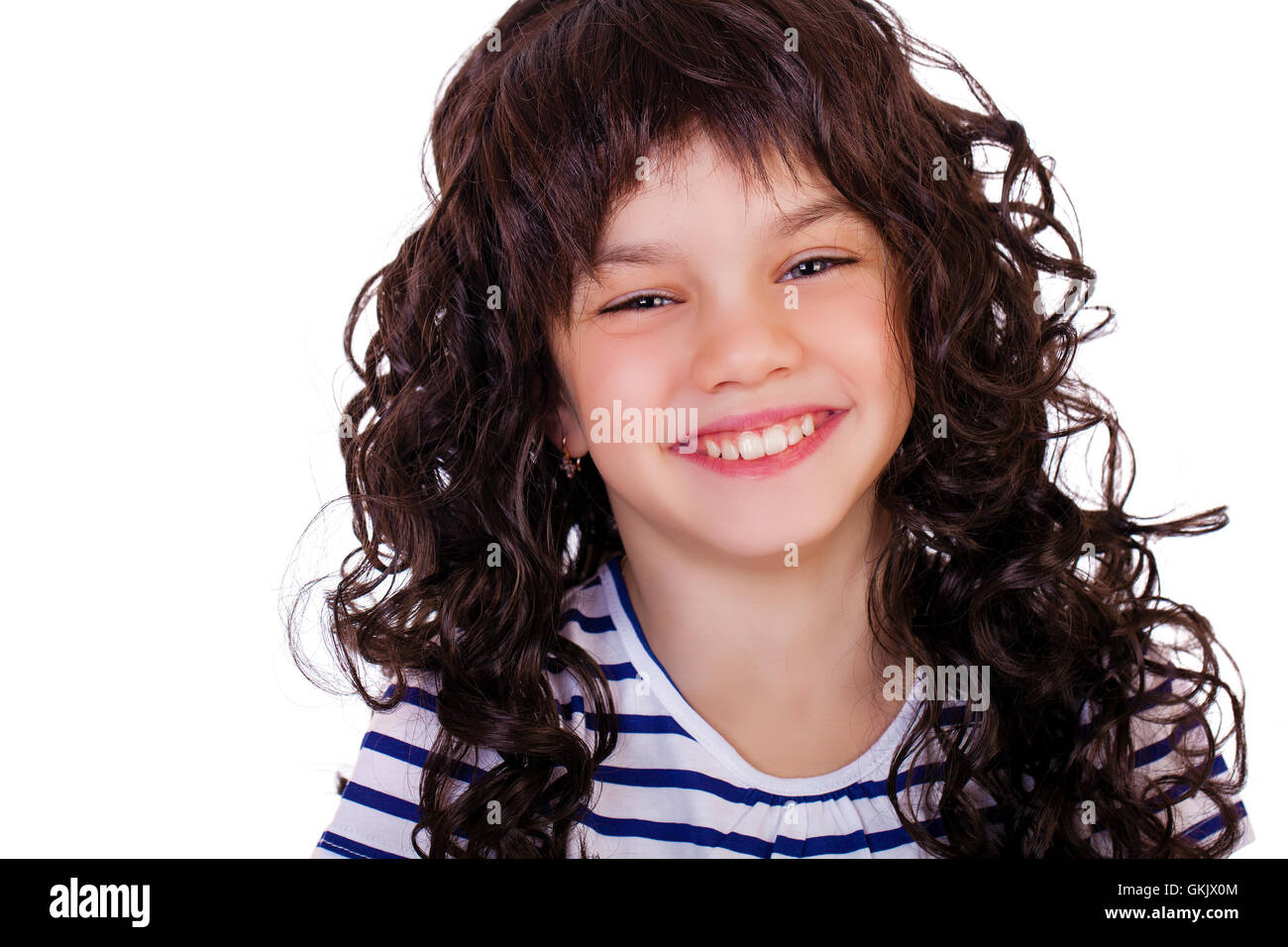 Portrait of a charming little girl smiling at camera, isolated on white ...