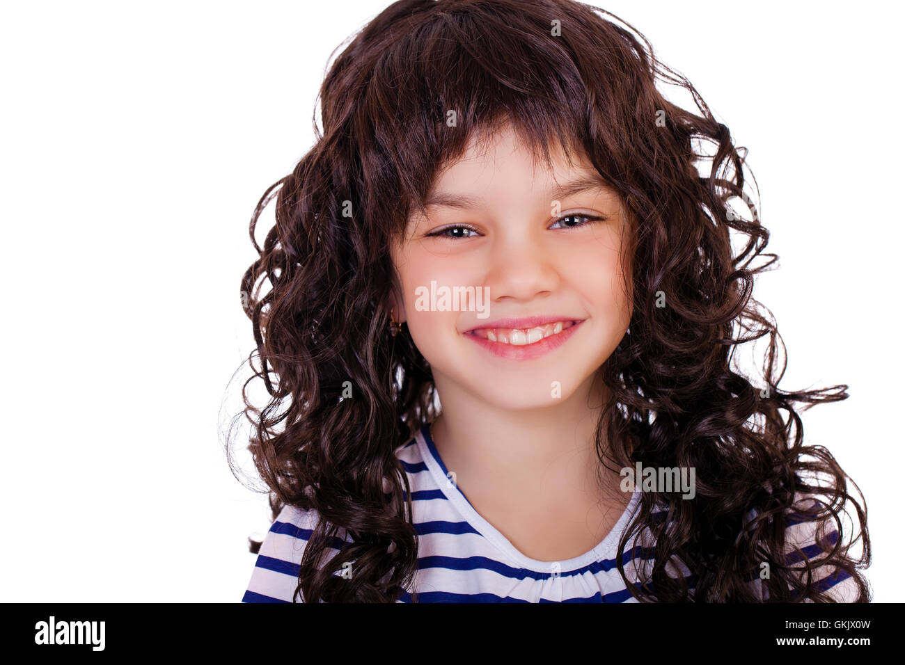 Portrait of a charming little girl smiling at camera, isolated on white ...