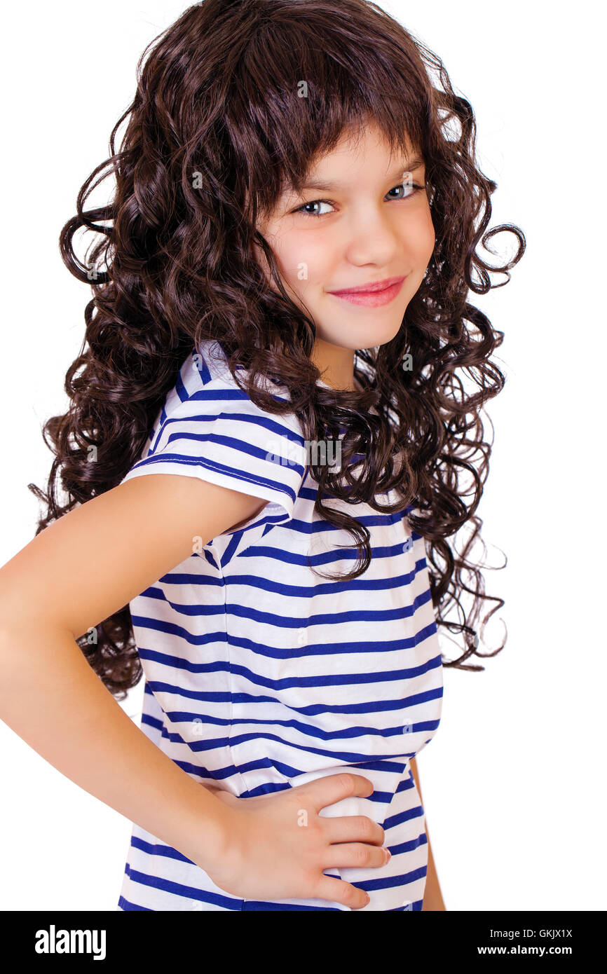 Portrait of a charming little girl smiling at camera, isolated on white ...
