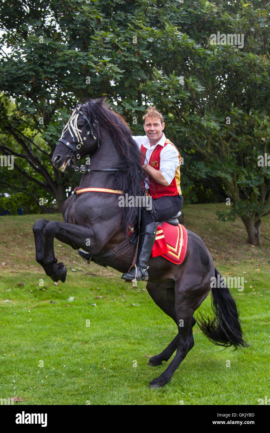 Jonathan Marshall with his stallion Le Colonel a display incorporating dancing Spanish Lusitano and Andalusian horses and birds of prey.  The falcons chase a swung lure at over 100 mph while the horses perform high schooled dressage moves such as Piaffe, passage and Spanish walk in the Victoria Park arena during the Southport Flower Show 2016. Stock Photo