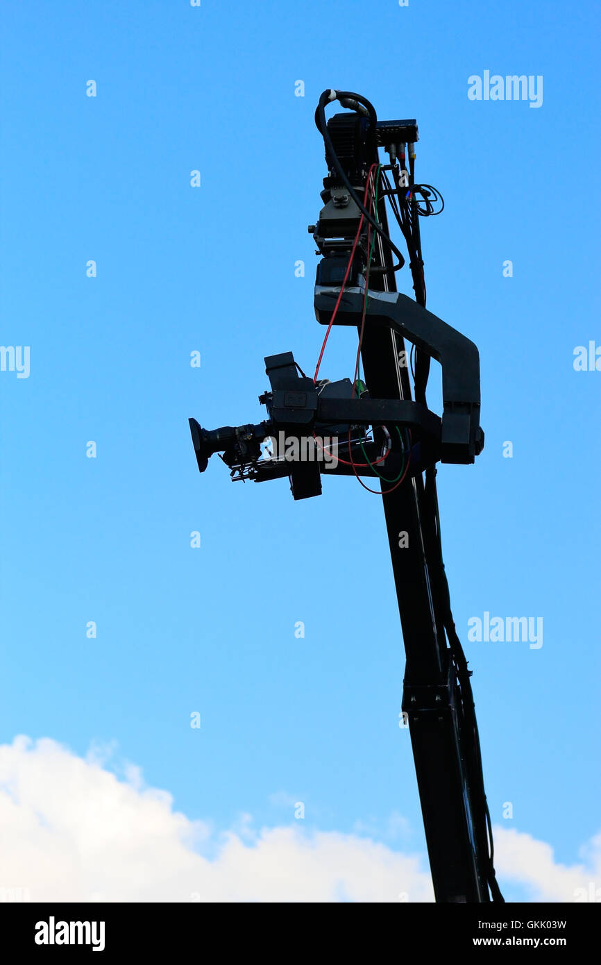 Professional TV camera on a crane against sky. Stock Photo