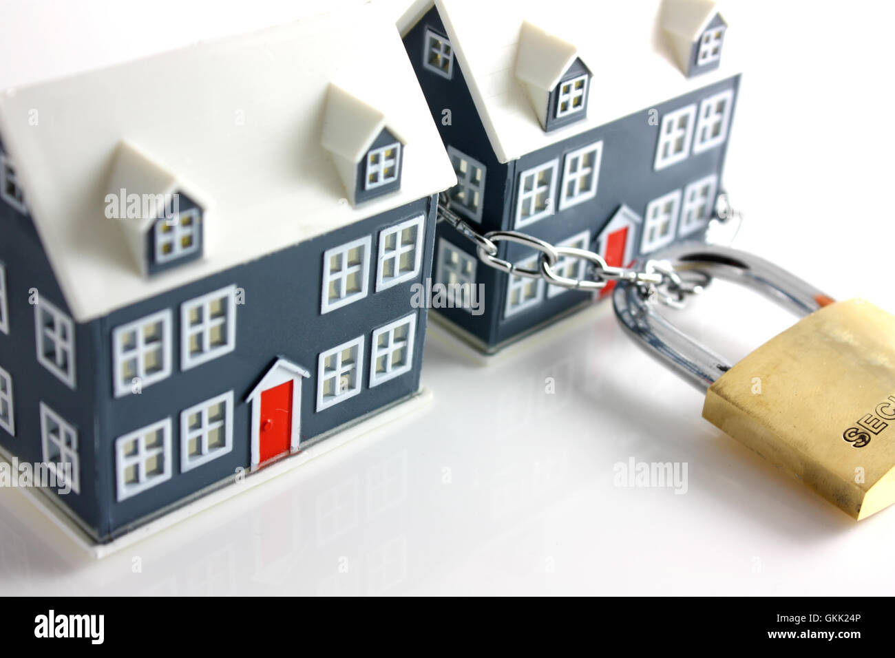 One secure and one unsecured house Stock Photo