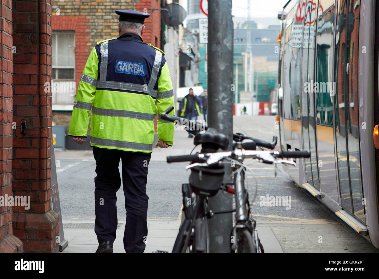 irish garda police sergeant on foot patrol in dublin city centre Ireland Stock Photo