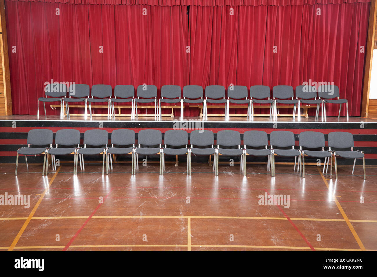 rows of empty chairs arranged for school photo in school hall in the uk