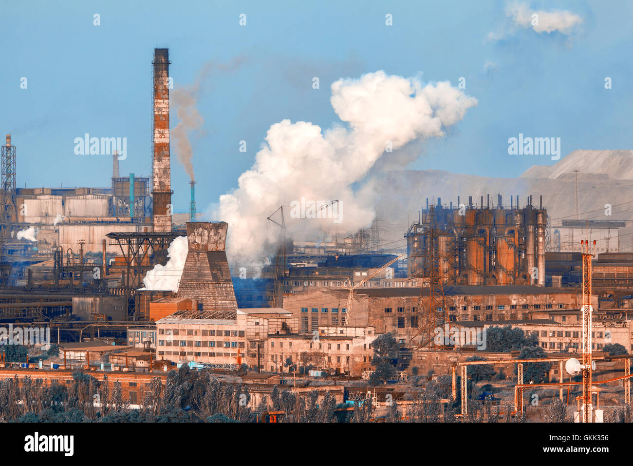 Metallurgical plant. Industrial landscape. Steel factory at sunset. Pipes with smoke. steelworks, iron works. Heavy industry in  Stock Photo
