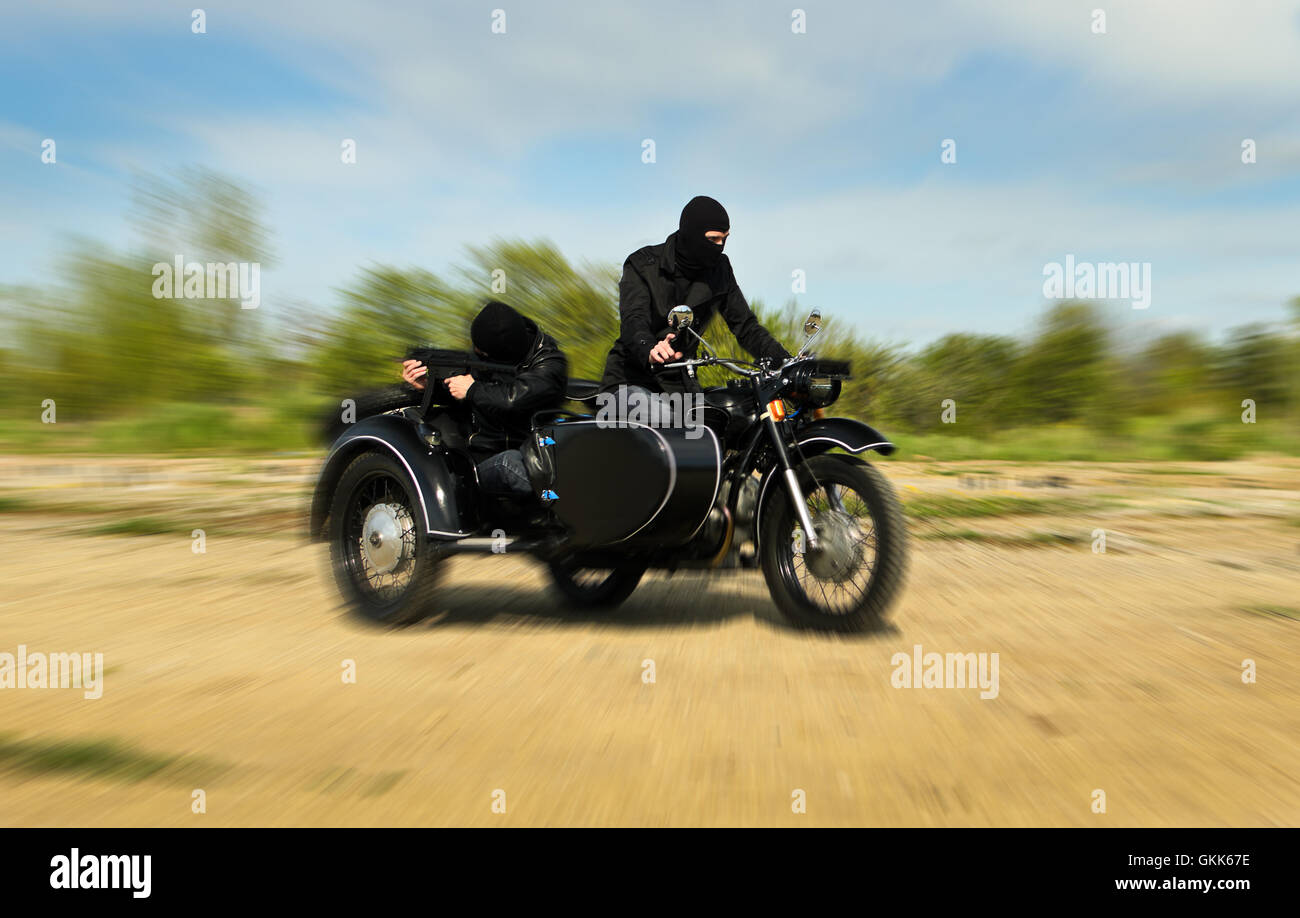 Two armed men riding a motorcycle with a sidecar. Motion blur Stock ...
