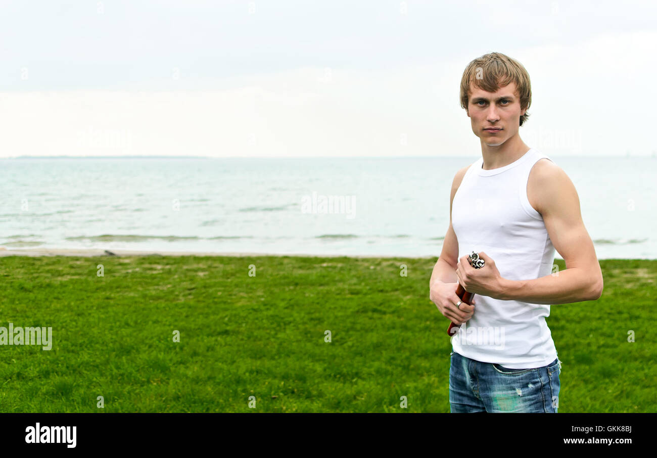 Martial arts: Man with nunchaku. Place for text. Stock Photo