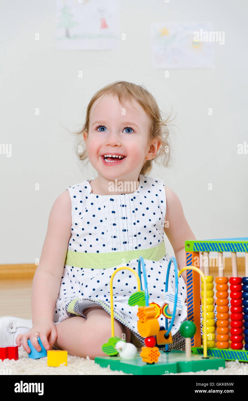 Little girl playing in a developing toy Stock Photo - Alamy