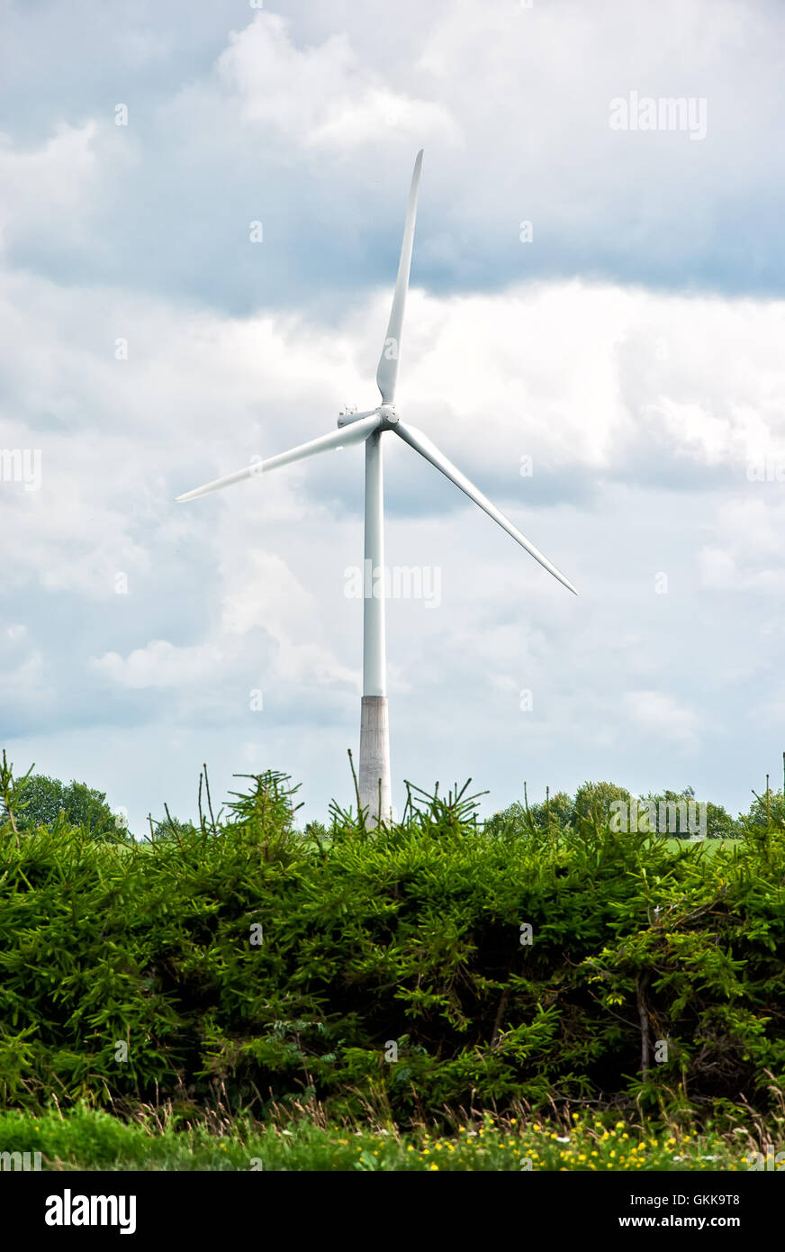 Wind turbine on a cloudy sky background Stock Photo - Alamy