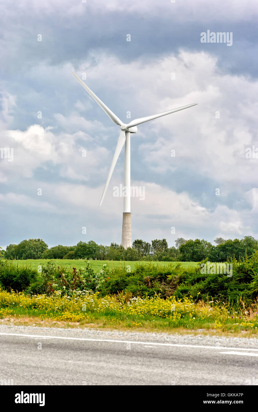 Wind turbine on a cloudy sky background Stock Photo - Alamy