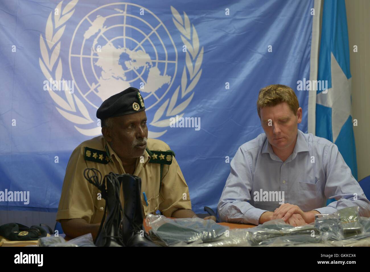 Regional coordinator of UNODC Alan Cole listens to Prison Commissioner Gen. Hussein Hassan Osman  during a handover of Uniforms to Somali Custodial Corps on 19th February 2014 Stock Photo