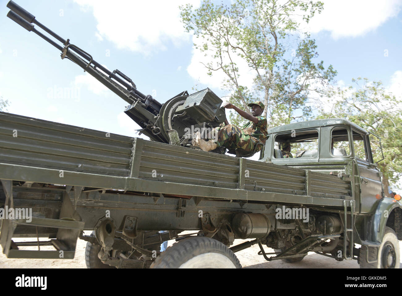 A soldier mans an anti aircraft gun mounted on a truck as it is driven past the presidential dias during the 54th Anniversary of the Somali National Army held at the Army Headquarters on 12th April 2014. AU UN IST PHOTO / David Mutua Stock Photo