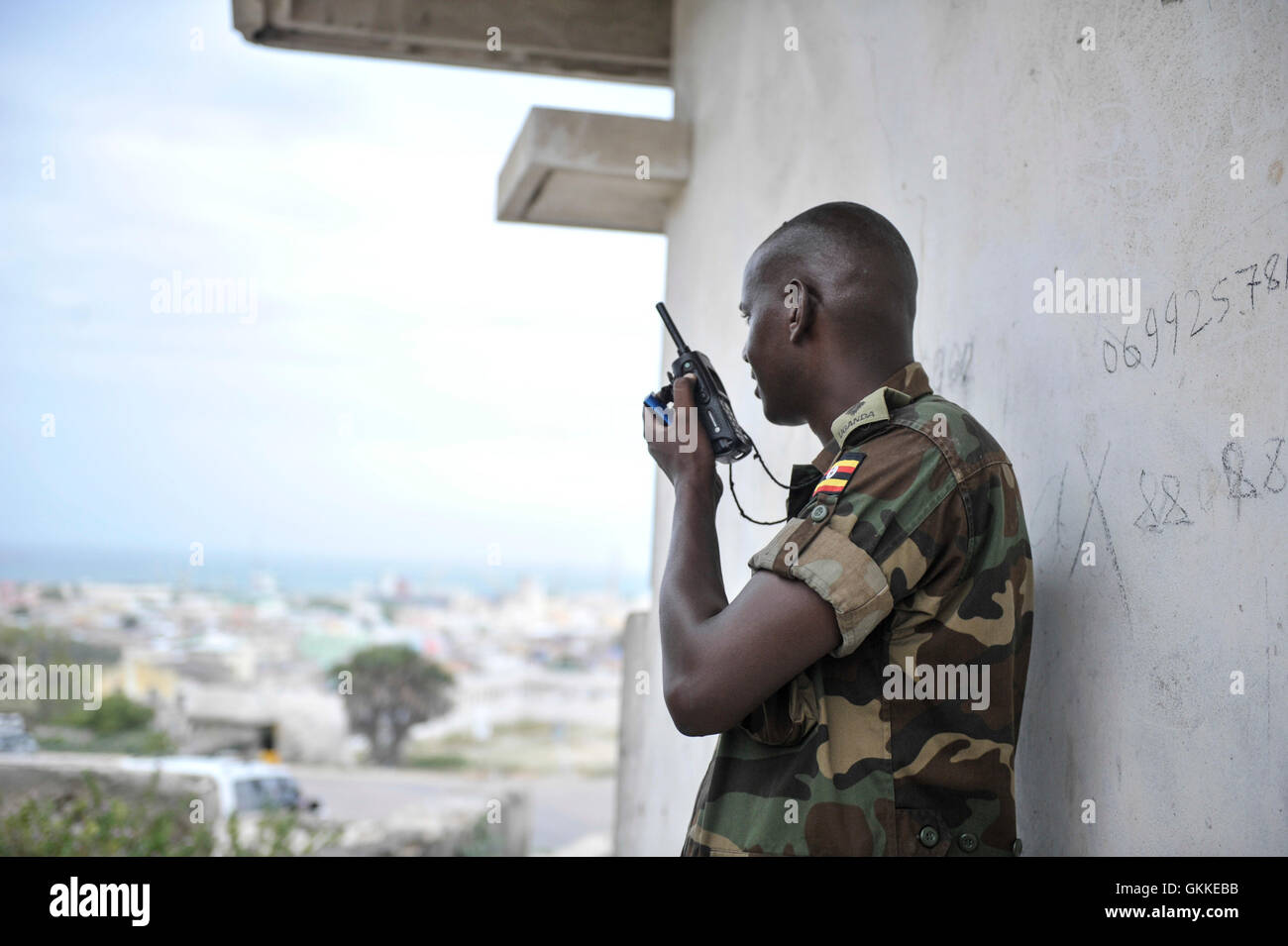 An AMISOM soldier communicating via radio outside parliament during an attack by Alshabaab on the building on 24th May 2014. AU/UNIST Photo/David Mutua Stock Photo