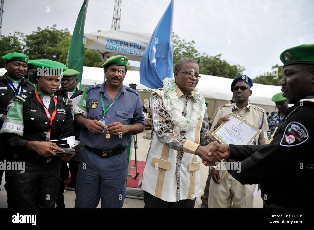 The Special Representative of the Chairperson of the African Union Commission (SRCC) for Somalia, Ambassador Maman S. Sidikou gives a certificate to a memeber of Nigerian AMISOM Police during a medal award ceremony for Nigeria Formed Police Unit  on December 05 2014 at Mogadishu Stadium, Somalia. The medals were being awarded to 140 police men and women who are about to complete their deployment to Somalia. AU UN IST Photo/ Ilyas Ahmed Stock Photo