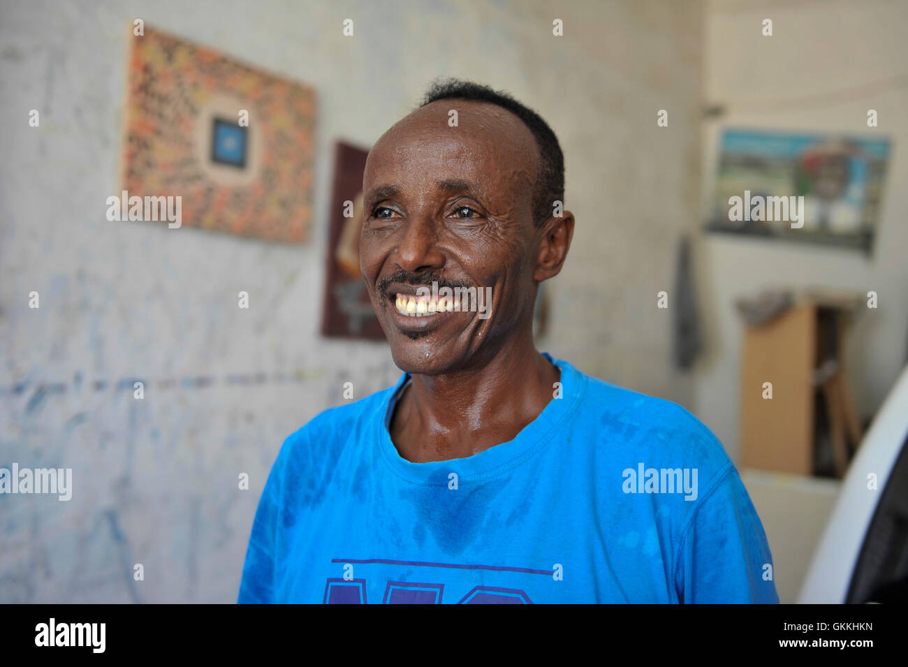 A Somali artist, Adan Farah Afey, works at the Centre for Research and Dialogue (CRD) art studio in the Wadajir District of the Somali capital Mogadishu on April 26, 2015. Many Somali artists are now able to practice their art, educating the masses on social issues, promoting peace and advocating for good governance and unity, among other issues.  Mogadishu and most parts areas of Somalia are now enjoying the longest period of peace in years after sustained military operations by the Somali National Army (SNA) backed by African Union Mission in Somalia (AMISOM) forced Al shabab to retreat from Stock Photo