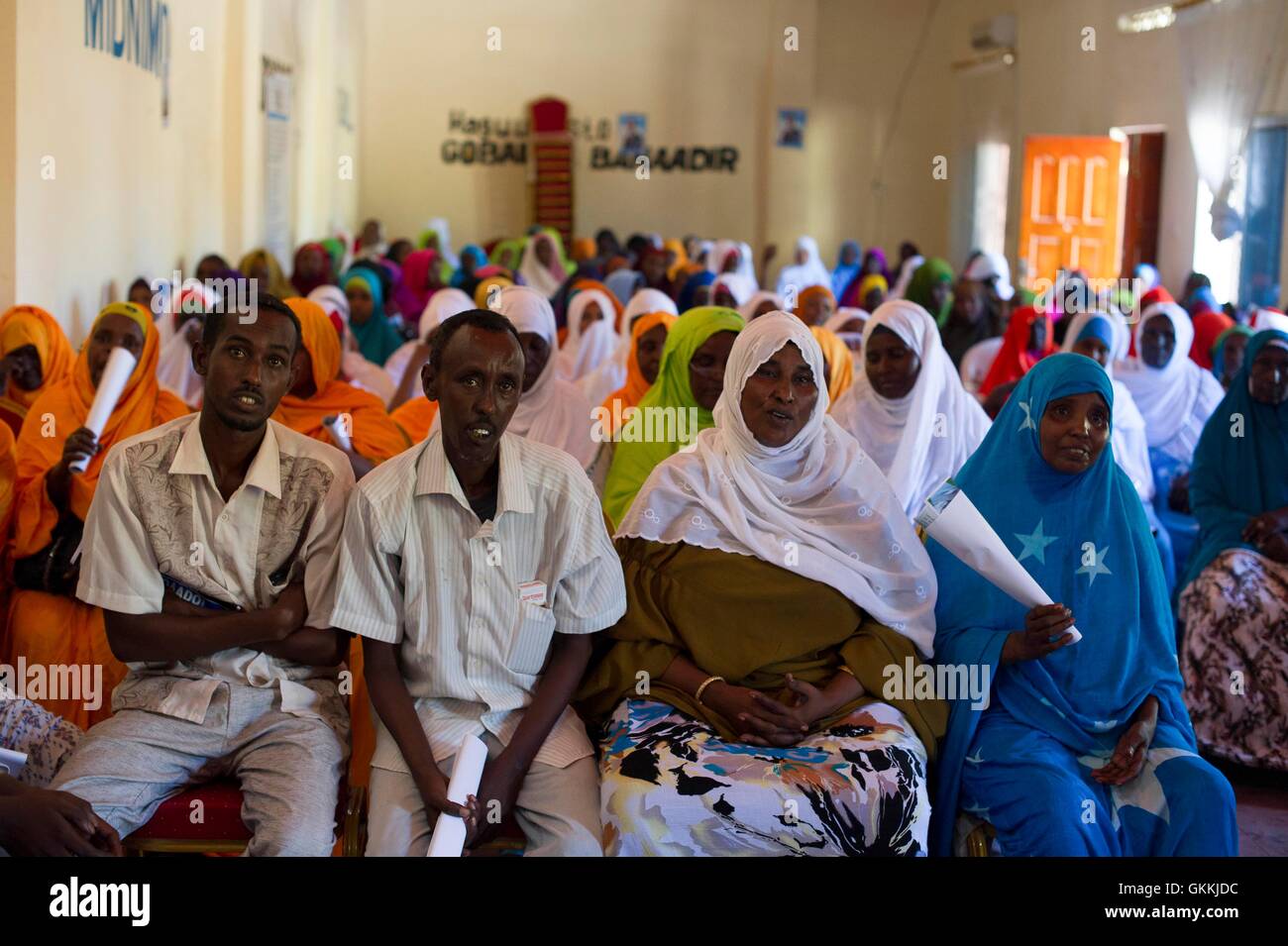 Two Somali men and Somali women seen during a town hall meeting jointly oganized by local authorities, Somalia Police Force and AMISOM Police at Warta Nabadda district in Mogadishu headqauters to discuss about community policing held on 6 May 2015. AMISOM Photo/Omar Abdisalan. Stock Photo