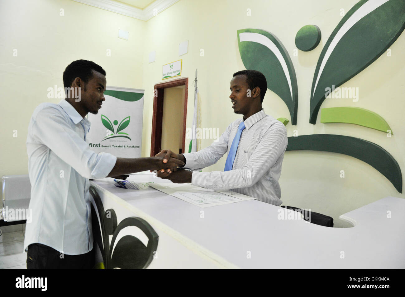 A customer service officer (right) attends to a client at the offices