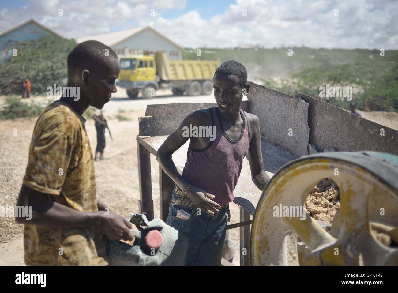 Workers place rocks in a grinder in order to create gravel at a quarry in Mogadishu, Somalia, on April 10. AMISOM Photo / Tobin Jones Stock Photo