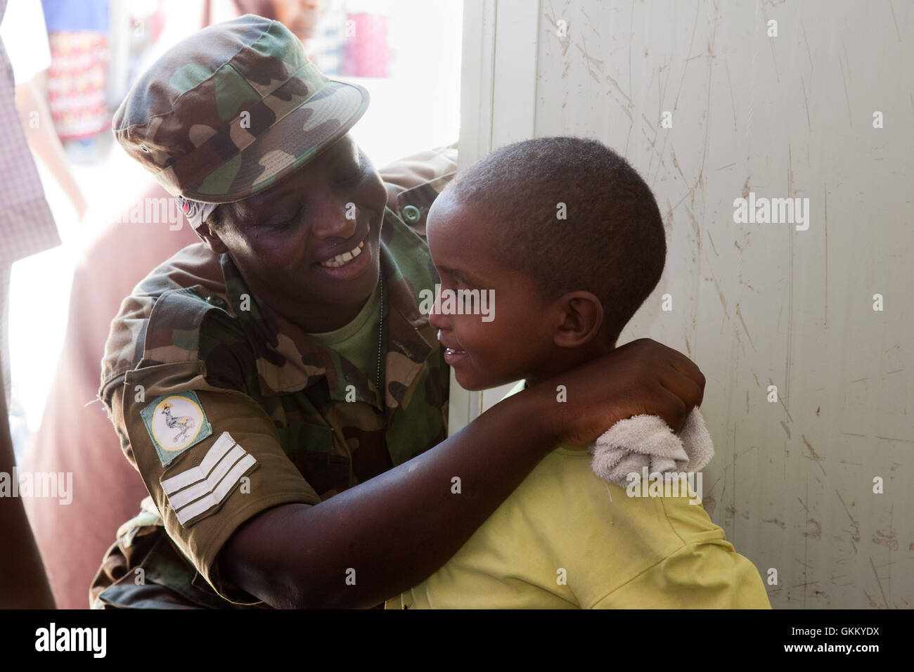 An AMISOM nurse caring for a young boy at the Out Patients Department in Mogadishu, Somalia Stock Photo
