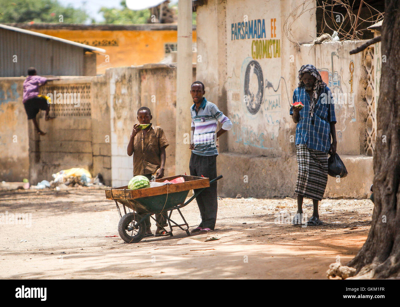 SOMALIA, Kismayo, In a photograph taken and released by the African Union-United Nations Information Support Team 07 October, Somali civilians eat water melon brought from a roadside vendor in the centre of the southern Somali port city of Kismayo, approx. 500km south of the country's capital Mogadishu. AU-UN IST PHOTO / STUART PRICE. Stock Photo