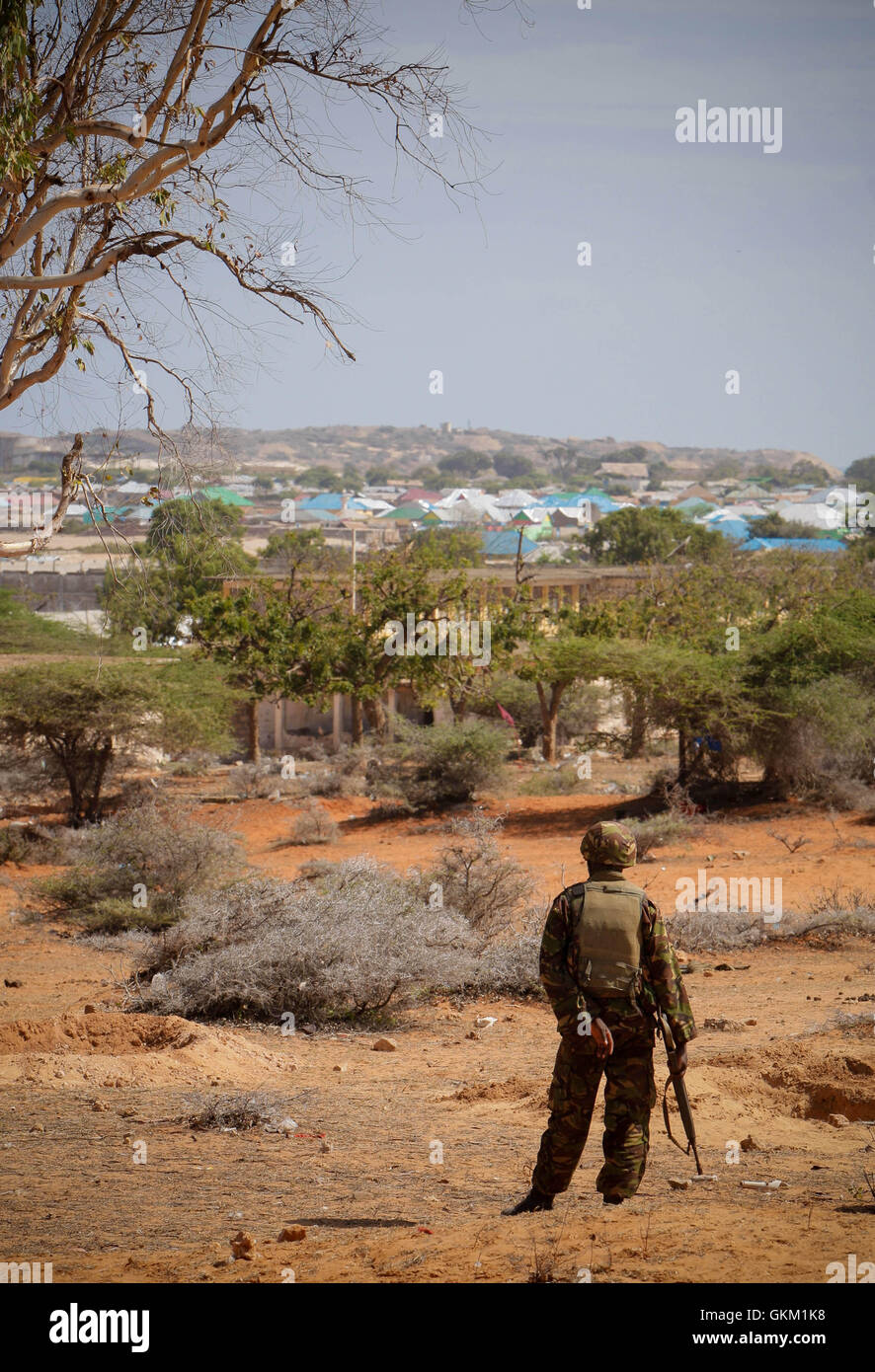 SOMALIA, Kismayo: In a handout photograph released by the African Union-United Nations Information Support Team 03 October, a soldier serving with the Kenyan Contingent of the African Union Mission in Somalia (AMISOM) looks out of the southern Somali port city of Kismayo, during a security sweep of a former police station by a team of AMISOM engineers for improvised explosive devices (IEDs). The Al-Qaeda-affiliated extremist group Al Shabaab withdrew from the city on 02 October after AMISOM troops, Somali National Army (SNA) forces and the pro-government Ras Kimboni Brigade militia entered and Stock Photo