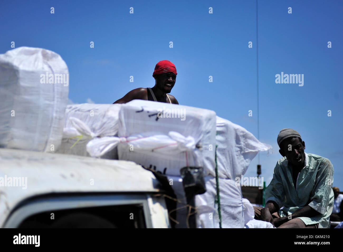 Somalis in the Southern city of Kismayo work in the city's seaport. Almost two months after the Kenya Defense Forces liberated Kismayo on the 2nd October, as part of the African Union Mission in Somalia, economic activity has resumed in the city. AU-UN IST PHOTO / TOBIN JONES. Stock Photo