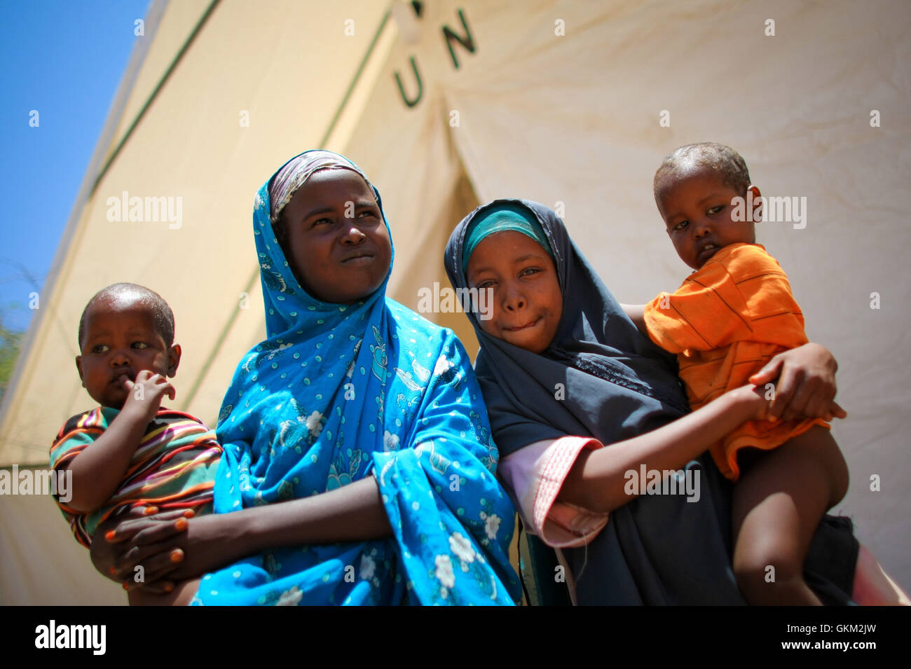 Two Somali Girls With Their Twin Brothers Outside A Tented OPD Clinic Two Somali Girls With Their Twin Brothers Outside A Tented OPD Clinic