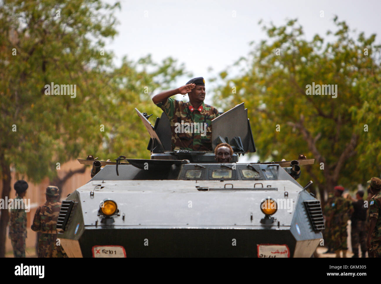 SOMALIA, Mogadishu: In photograph taken and released by the African Union-United Nations Information Support Team 12 April 2013, a gunner of an armoured personnel carrier of the Somali National Army salutes during a military parade marking the 53rd Anniversary of the SNA held at the newly refurbished Ministry of Defence in the Somali capital Mogadishu. Somalia is rebuilding it's army, along with many state institutions and facilities after being racked by years of internal conflict and division and is enjoying it's longest period of relative peace since major operations by the SNA supported by Stock Photo