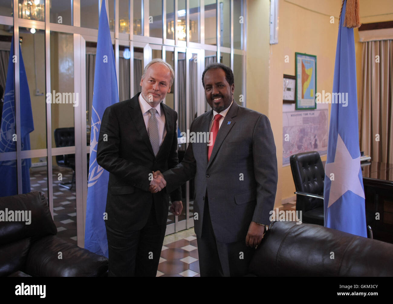 SOMALIA, Mogadishu: In a photograph taken and released by the African Union-United Nations Information Support Team 08 June 2013, Special Representative of the Secretary-General (SRSG) for Somalia, Nicholas Kay, is greeted by Somali President Hassan Sheikh Mohamud inside his presidential offices at Villa Somalia, the complex in central Mogadishu that houses the Federal Government of Somalia. The head of the new United Nations Assistance Mission in Somalia (UNSOM) Kay, today called for an immediate end to fighting in Somalia's southern port city of Kismayo, urging all parties to commit to resol Stock Photo